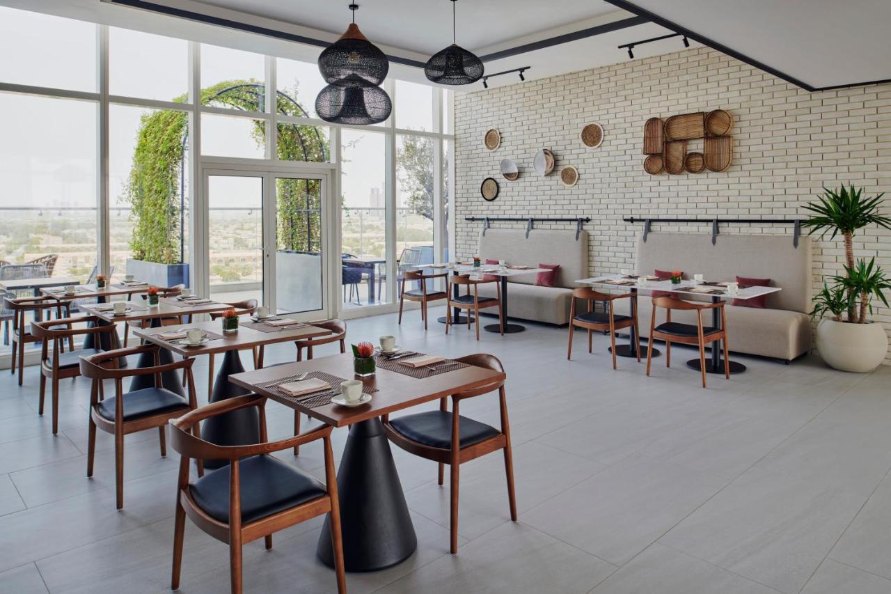 Movenpick Jumeirah Village Triangle Dubai Esterno foto Restaurant